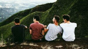 Quatre hommes assis en haut d'une colline.